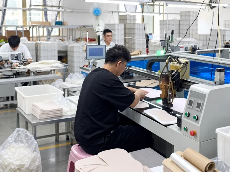 Workers preparing garment components at a cutting workstation